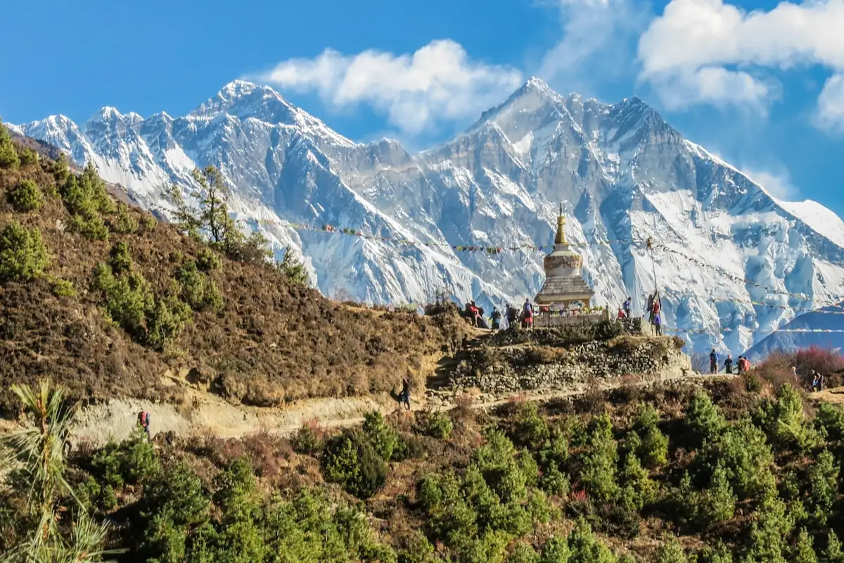 Majestic snow-capped mountain peaks towering over a high-altitude valley on the Annapurna Circuit trek