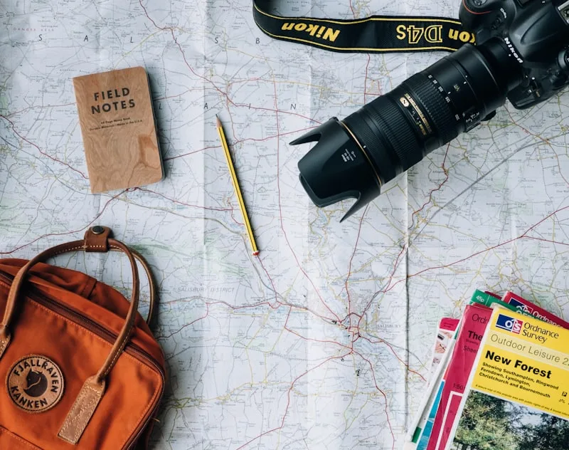Travel journal, map, and a cup of coffee on a cozy cafe table